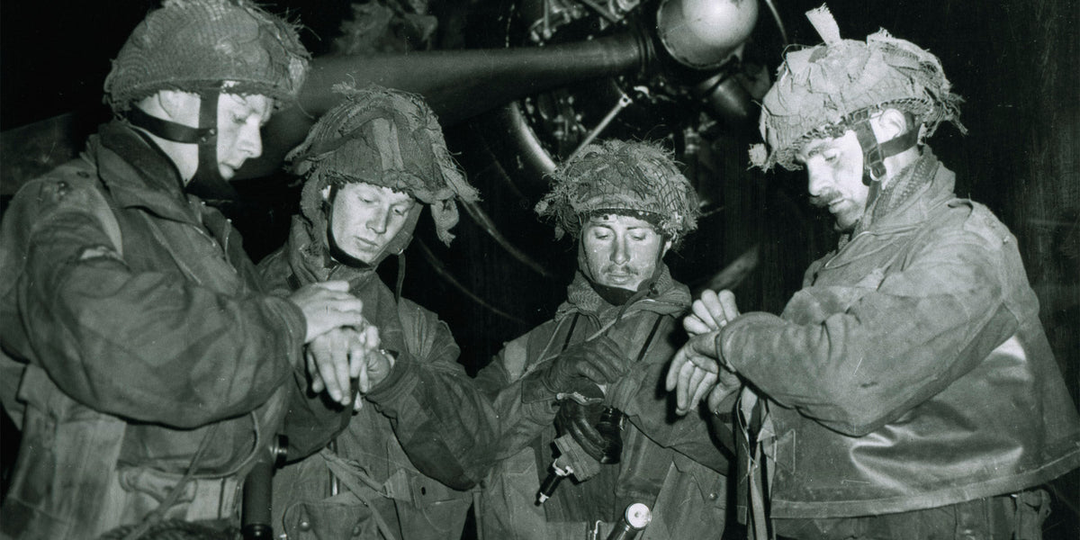 British pathfinders synchronizing their watches before flying to Normandy on June 5, 1944.