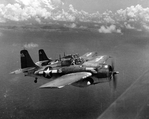 Black and white photo of WWII F4F Wildcat fighter planes in flight