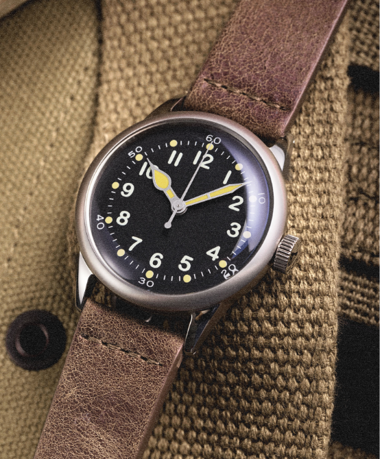 A-11 Tom Rice black dial on a brown leather strap, worn on the wrist