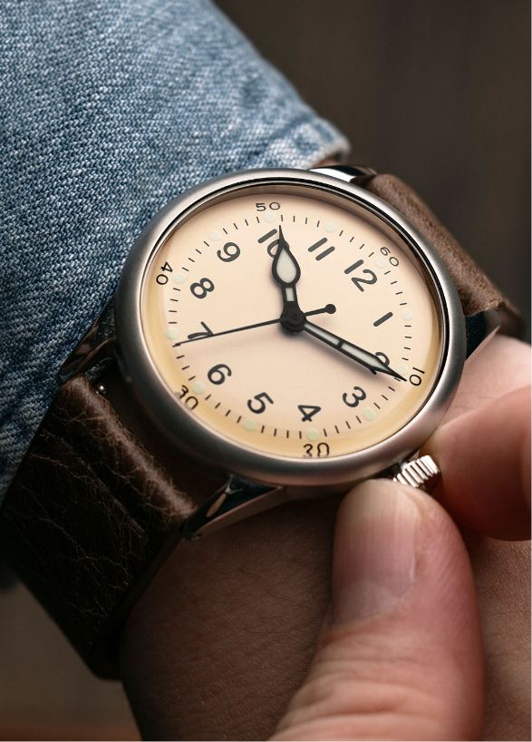 A-11 Vince Speranza cream dial watch, held on the wrist