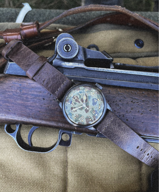 A-11 Vince Speranza watch on a vintage leather strap next to a WWII rifle