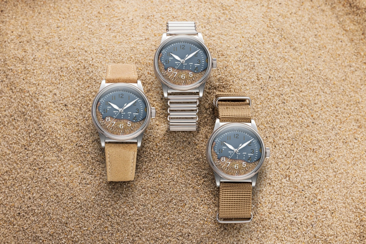 Higgins Blue watches on leather, Bonklip and NATO straps, resting on sand.