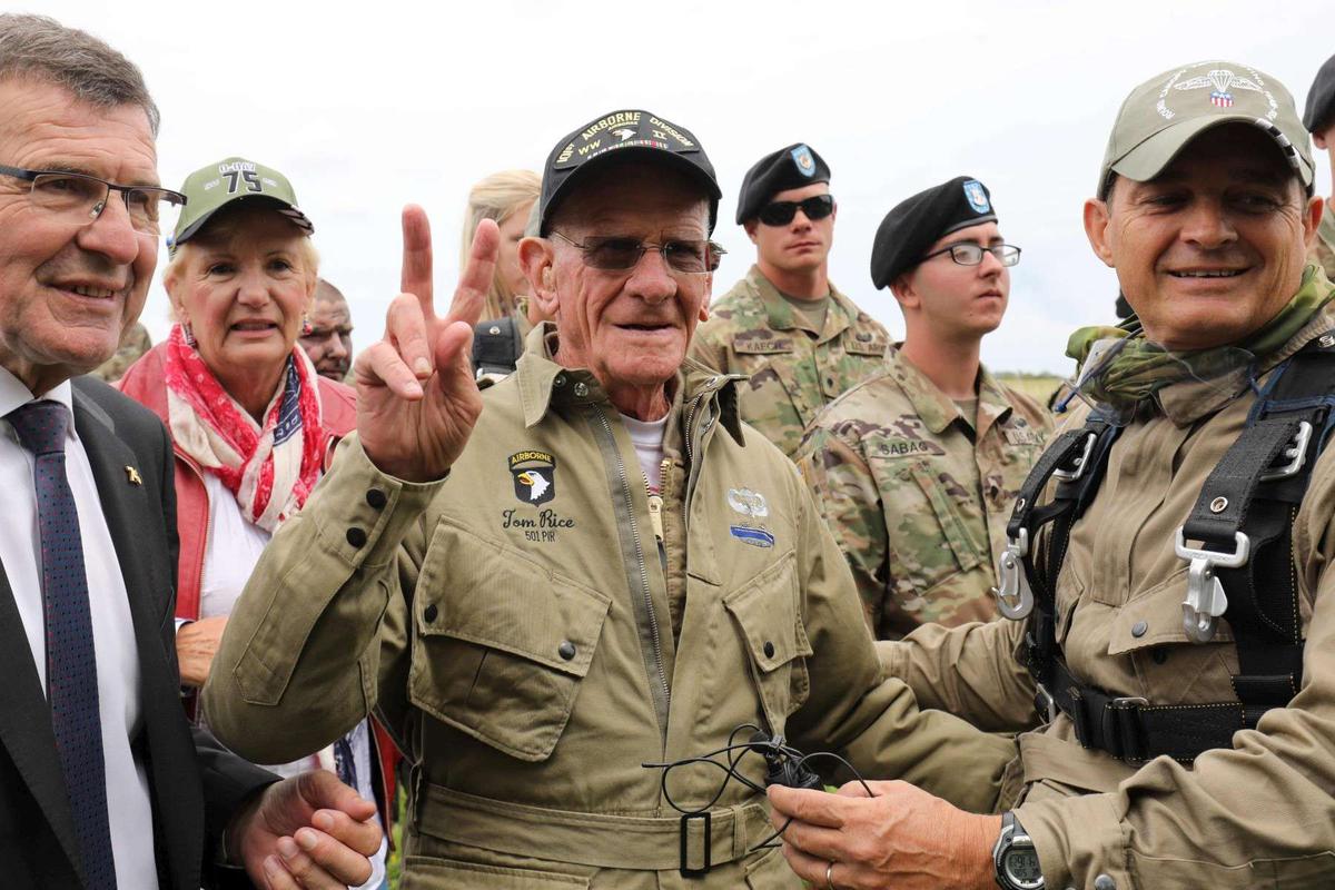 Tom Rice surrounded by visitors and service members.