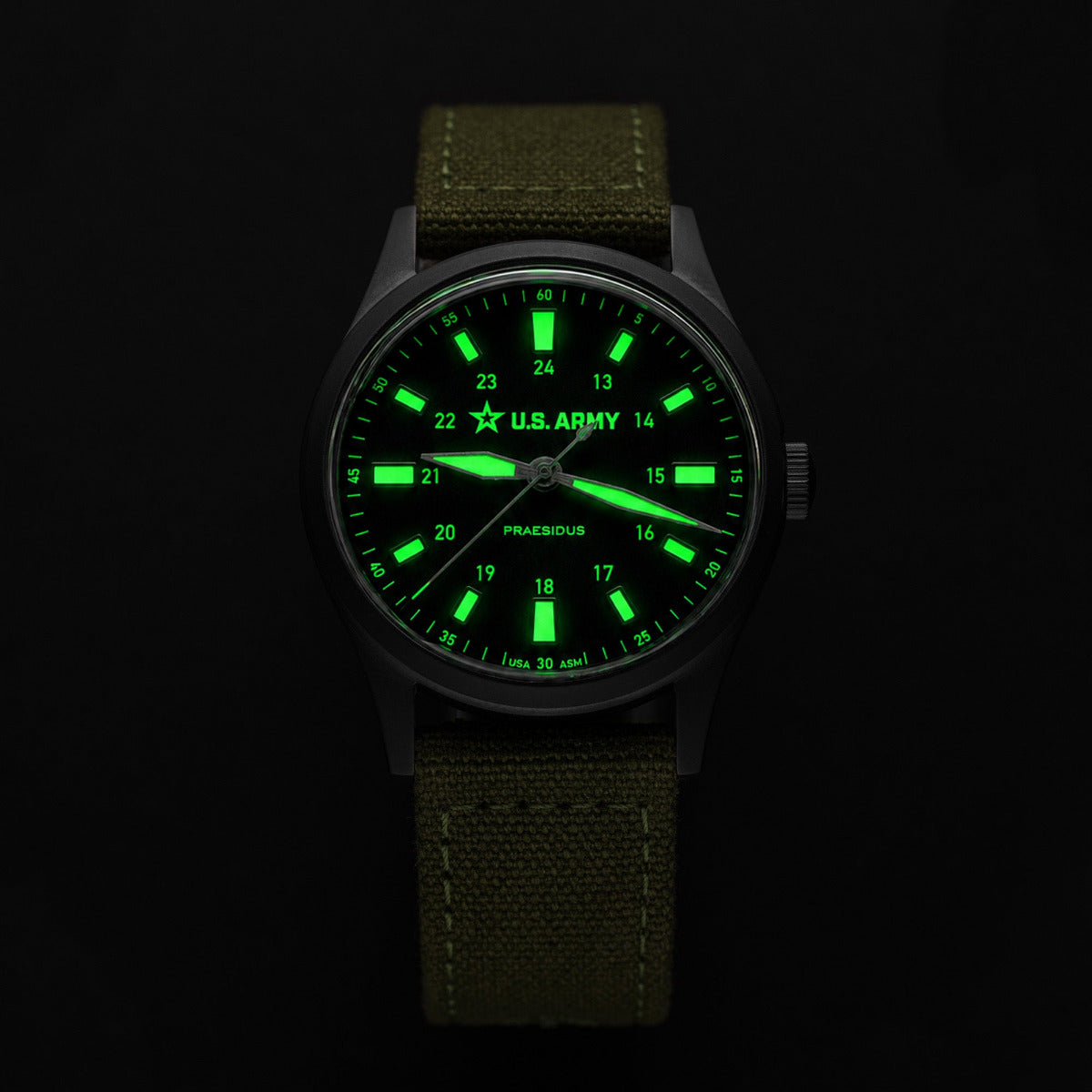 Watch with green glowing face and U.S. Army logo on a black background