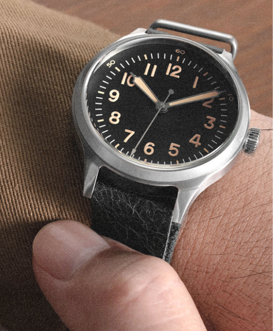A-11 black dial watch on a dark strap, worn on the wrist