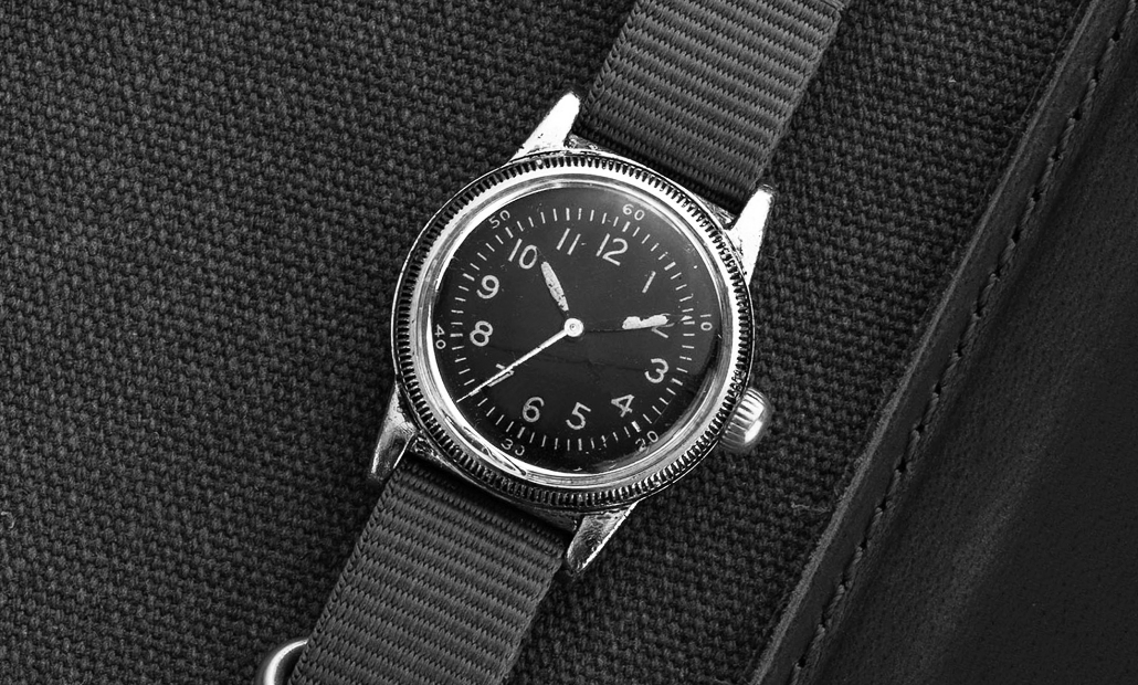A-11 field watch with a black dial on a gray strap