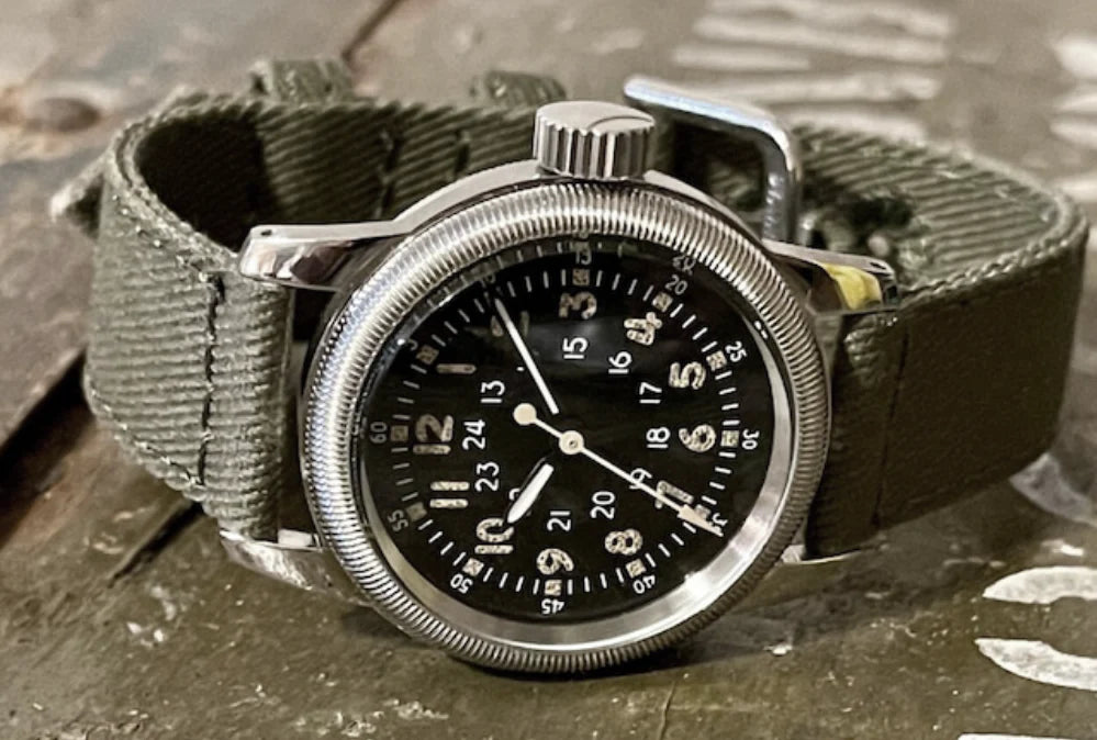 A-2 pilot watch with black dial on a green strap