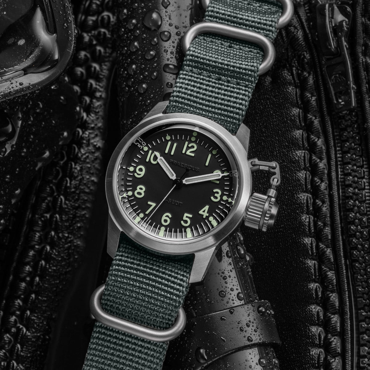 A-5 UDT black military field watch with OG-107 NATO strap in rugged outdoor setting with water droplets